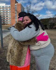Restore Hope volunteer hugging a shelter resident
